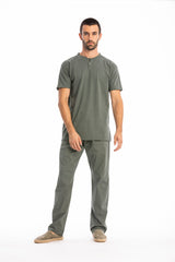 Man wearing a green t-shirt and pants on a white background