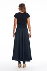 Woman wearing a long dress with short sleeves on a white background