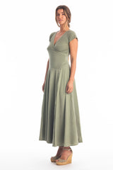 Woman wearing a long V-neck khaki dress with short sleeves on a white background