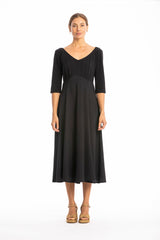 Woman wearing a black dress on a white background