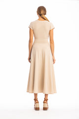 Woman wearing a beige dress on a white background